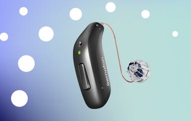 Silver Bernafon Encanta hearing aid displayed on changing blue background with white Bernafon twirl.